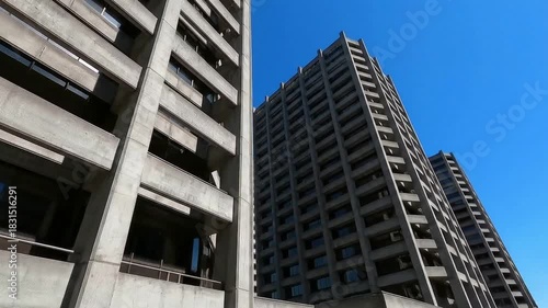 Wallpaper Mural Tall building filmed from low angle against blue sky, modern and monumental. Torontodigital.ca