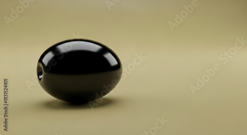 Glossy black sphere with indentation on a minimalist beige background
