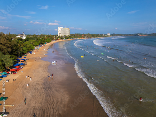 Aerial view of Weligama Beach with surfers riding the waves, Sri Lanka