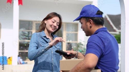Delivery man handing parcel boxes to Asian customer woman at house gate, friendly courier representing reliable logistics, customer satisfaction, and small business delivery service partnership
