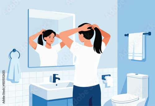 A woman in a bathroom views her reflection as she pulls her black hair into a ponytail