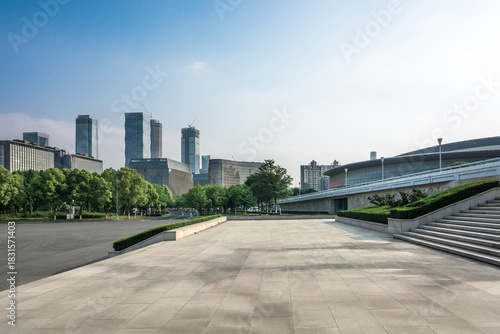 Modern Urban Skyline with Lush Greenery and Expansive Pavement Spaces