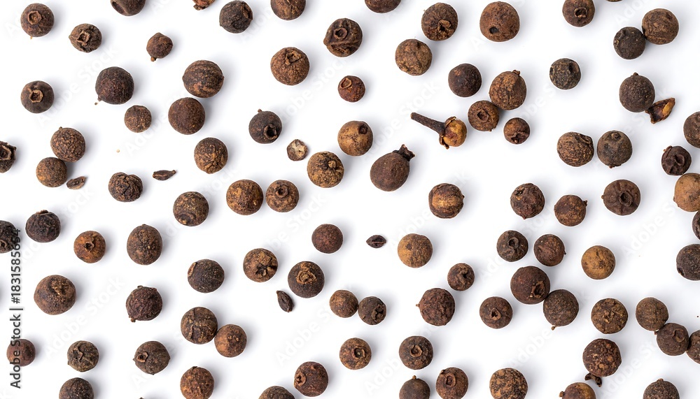 Obraz premium Overhead shot of scattered allspice berries on a white surface.