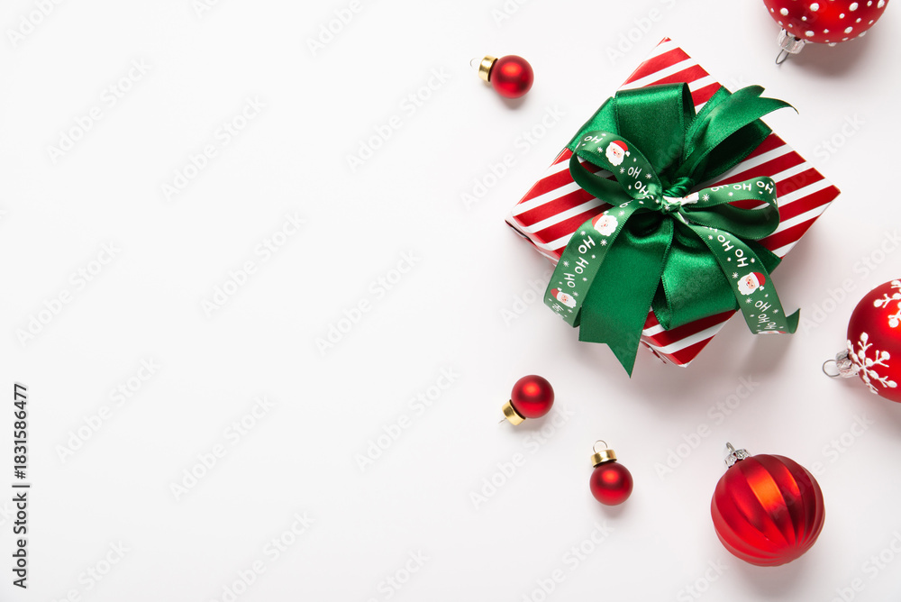 Naklejka premium Merry Christmas and Happy Holidays greeting card, frame, border, banner. New Year. Red green Christmas decoration, ornaments and gifts, presents on white background. Xmas holiday festive theme.