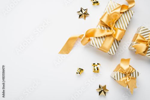 Merry Christmas and Happy Holidays greeting card, frame, border, banner. New Year. Golden Christmas decoration, ornaments and gifts, presents on white background. Xmas holiday festive theme.