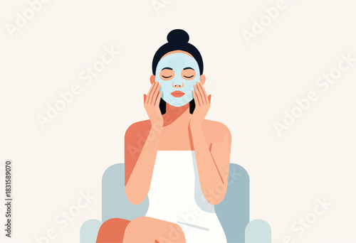 A person with dark hair, a face mask, and a white towel wrapped around them, sitting in a chair