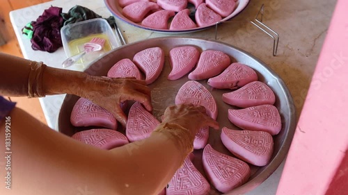 Women are cooking pink Chinese Sticky Rice Dumplings hands close up