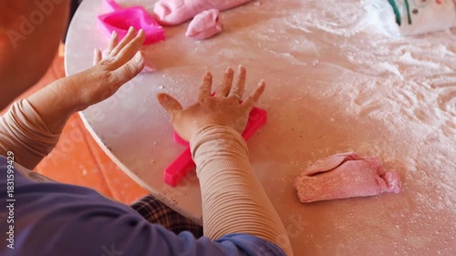 Women are cooking pink Chinese Sticky Rice Dumplings hands close up