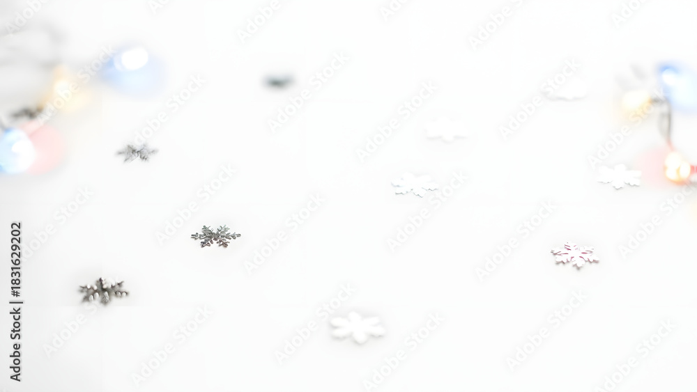 Fototapeta premium Delicate silver snowflakes scattered on a white background