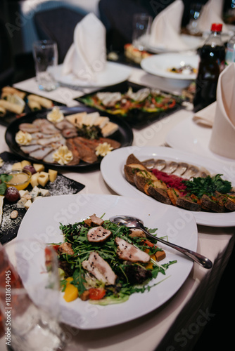 A table set for a banquet or celebration with a variety of dishes