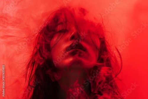 Artistic portrait of a young woman with closed eyes, enveloped in a swirling cloud of vibrant red smoke, creating a dramatic and mysterious atmosphere
