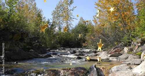 Gold stars appearing and drifting, rocky creek flowing toward foreground, decorating autumn scene