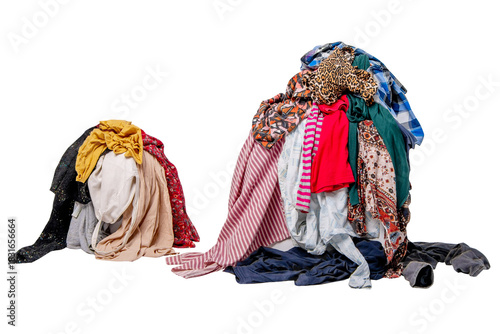 Two piles of second-hand clothes. Sorting used clothes.