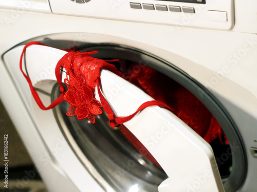 Red women's lingerie and an automatic washing machine.