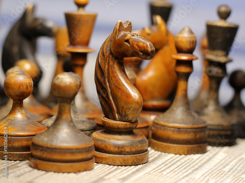Old retro wooden chess pieces, intellectual strategy game.