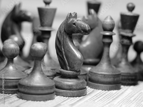Old retro wooden chess pieces, intellectual strategy game.
