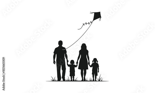 Silhouette of a family with two children flying a kite.