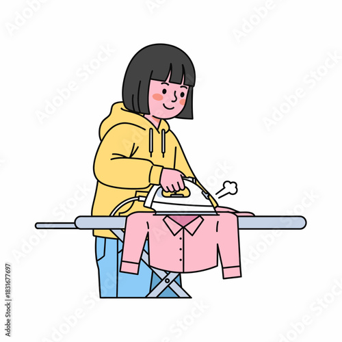 A cheerful young woman in a yellow hoodie carefully ironing a pink shirt on an ironing board