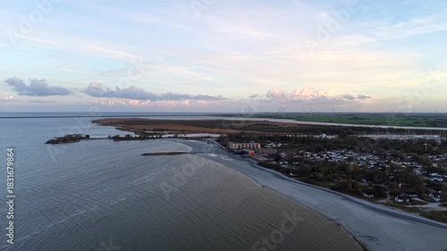 Wallpaper Mural Aerial view of Dutch IJsselmeer coastline during ebb tide, showing shallow water patterns, wind turbines in distance. Calm shoreline under soft evening light in Netherlands. Wide shot. Torontodigital.ca