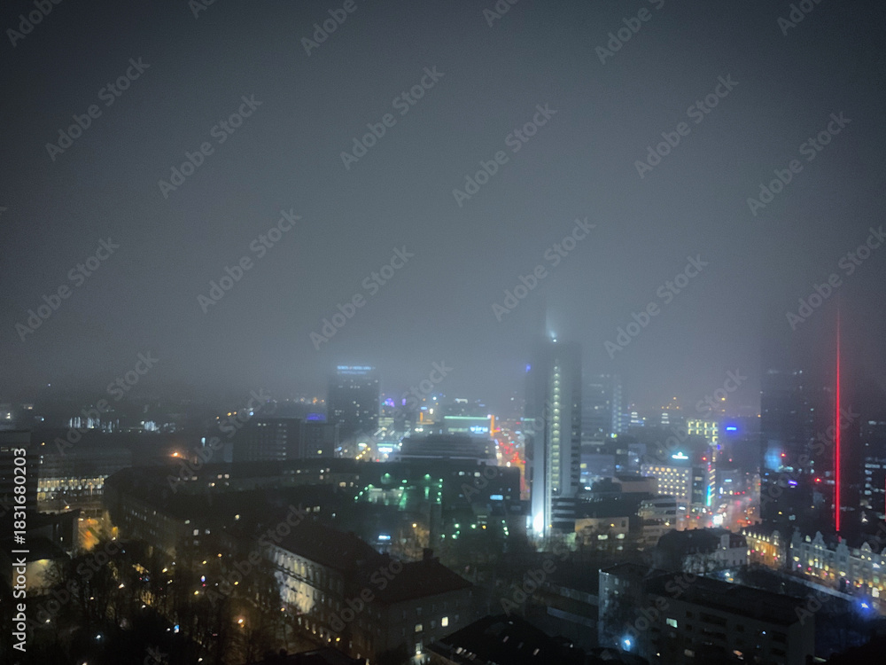 Fototapeta premium Foggy late autumn Tornimäe cityscape at night, Tallinn, Harjumaa, Estonia, November 2019