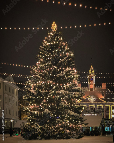 Festive Christmas Tree adorned with lights in the snowy Town Hall Square in Tartu, Tartumaa, Estonia, November 2021