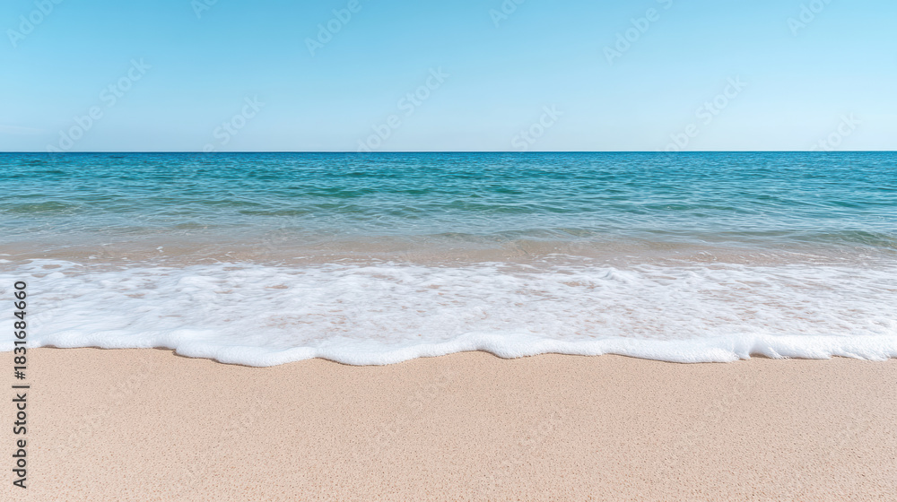 Fototapeta premium Clean coastline with gentle waves and soft sand evoking calmness