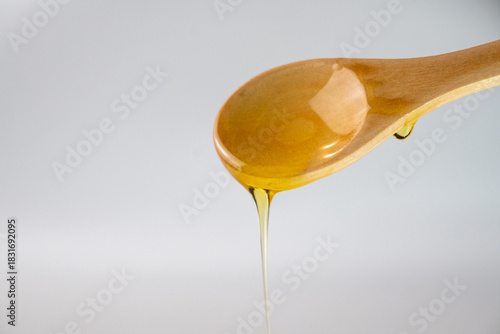 Wallpaper Mural Wooden spoon with dripping honey Torontodigital.ca