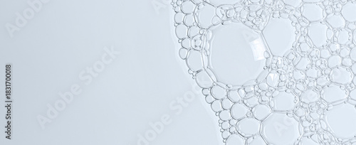 The texture of the foam of shower gel or soap suds or shaving foam. Macrophotography. Copy space