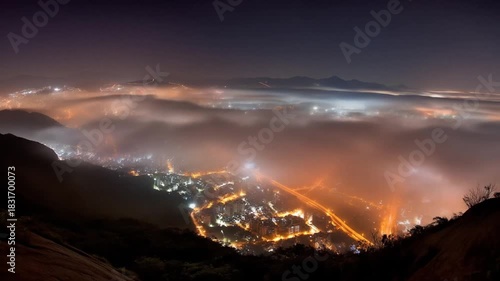 Night cityscape above the clouds illuminated with artificial light