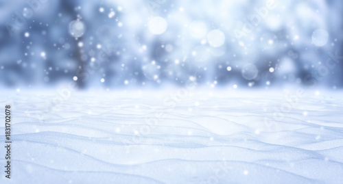 A winter Christmas snow background with snowdrifts against a backdrop of snow-covered trees and a beautiful bokeh lights with snowflakes and garlands. Banner format, copy space.