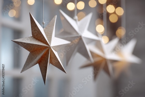 Delicate paper stars hang gracefully, surrounded by soft, glowin