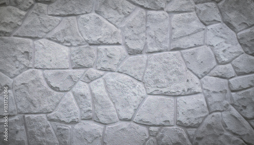 Detailed close-up of a gray stone wall with an irregular pattern, creating a textured background for design