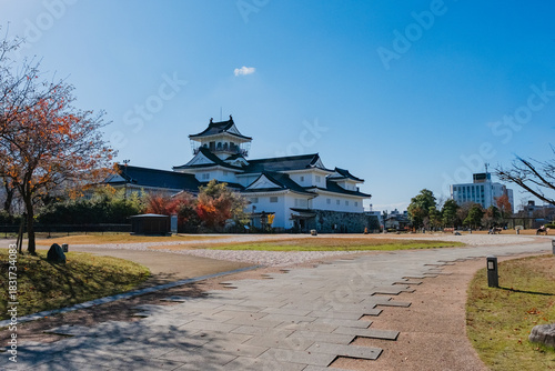 Toyama, japan - November29, 2025: Toyama Castle and Modern City Buildings Under Clear Blue Sky in Toyama, Japan