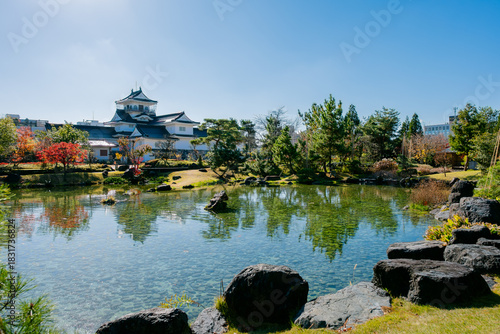 Toyama, japan - November29, 2025: Toyama Castle Reflected in Clear Pond During Autumn in Japan