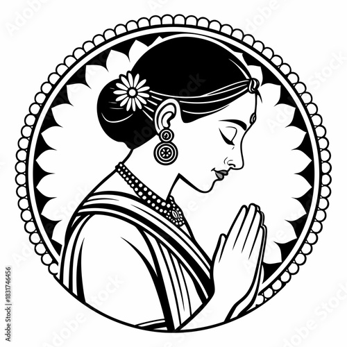 A woman in traditional attire, hands pressed together in a respectful greeting pose. She has her hair tied in a bun with a flower, wears jewelry, and is framed inside a decorative circular border.