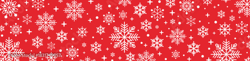 Festive seamless red and white Christmas pattern with decorative snowflakes, falling snow and stars, holiday winter background for greeting cards, wrapping paper and seasonal designs