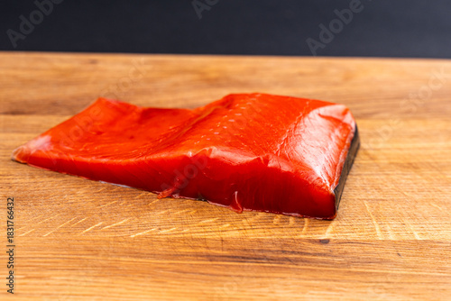 Salted Red Salmon Fillet Close-Up on Wooden Board