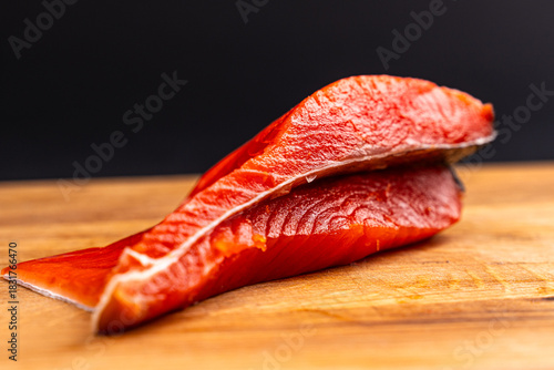 Salted Red Salmon Fillet Close-Up on Wooden Board