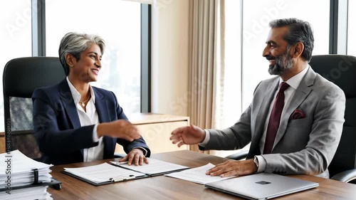 Wallpaper Mural Professional colleagues review documents at desk in office building Torontodigital.ca