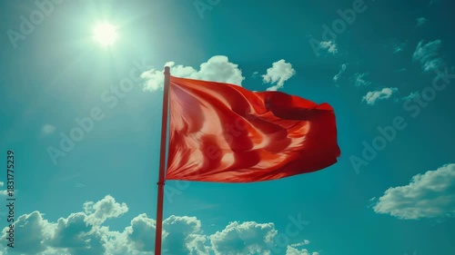 A red banner in the wind on a sunny day.