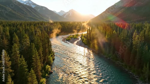 Serene river flowing through lush forest valley at sunrise with mountain backdrop