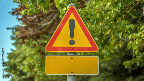 Be alert with this yellow and red exclamation road sign for safety awareness and compliance outdoors
