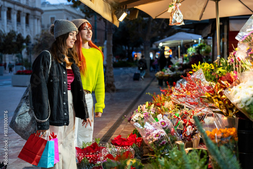 Gen z friends shopping for christmas flowers in valencia