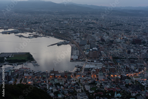 Dramatic sunset clouds and golden light illuminating the iconic cityscape of Hakodate, Hokkaido, viewed from Mount Hakodate.