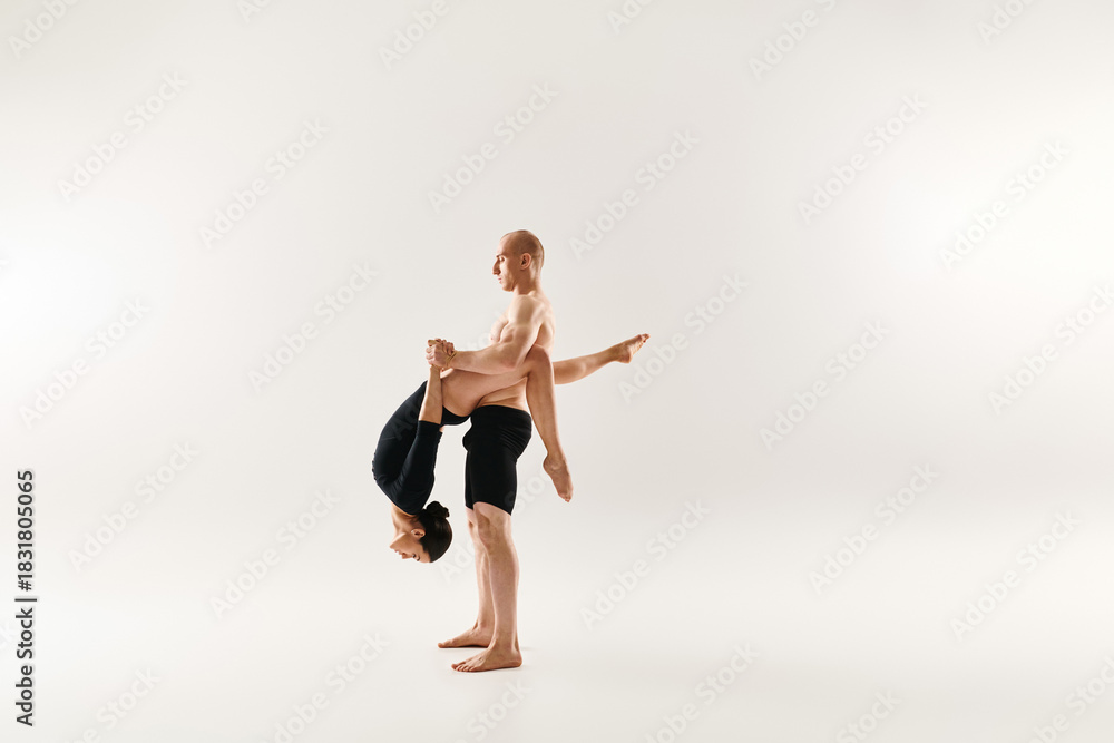 Obraz premium Dynamic duo showcases breathtaking acrobatic moves in a vibrant studio setting