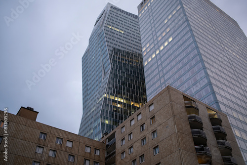 Skyscraper architecture interacts with residential and offices as contrast highlights every urban facade, illustrating the mixed use profile seen across Paris within La Defense
