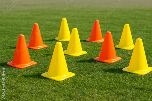Colorful soccer training cones on grass field