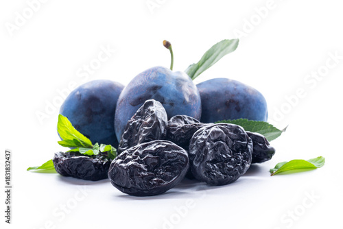 Natural blue plums and dried prunes with leaves