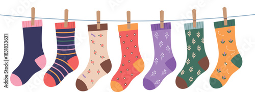 Cute cozy patterned socks hanging on clothesline in soft pastel colors perfect for autumn winter decorative vector illustration