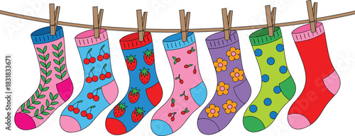 Cute colorful patterned socks hanging on clothesline with playful fruit and floral designs for fun children’s illustration